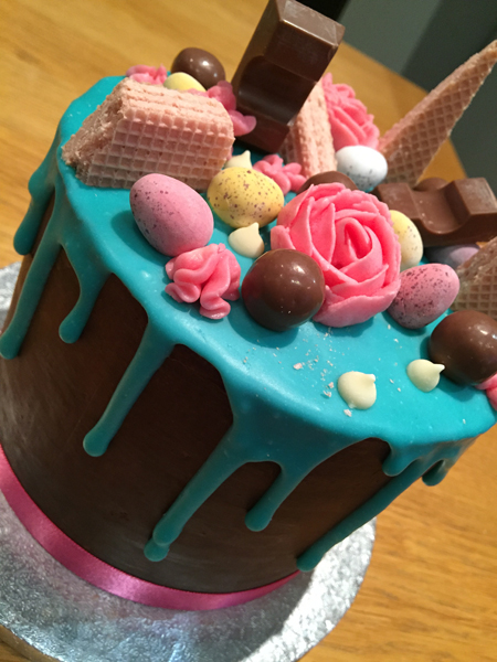 Layers of cake, covered in ganache and topped with lots of treats!